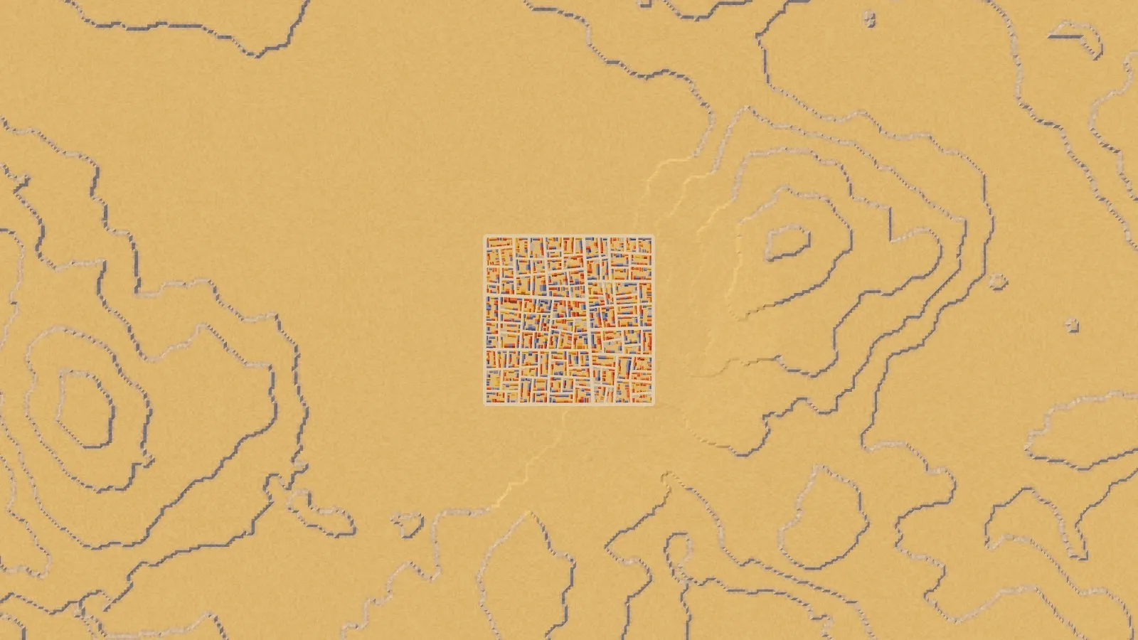 A sandy desert plateau seen from above with terraced rock steps and the town at its centre