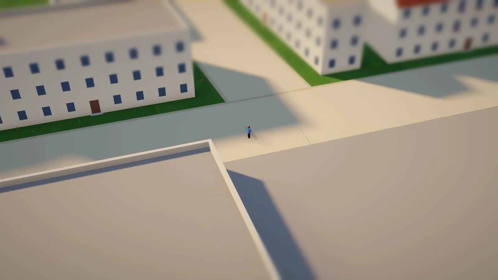 A single person walking along a street between buildings