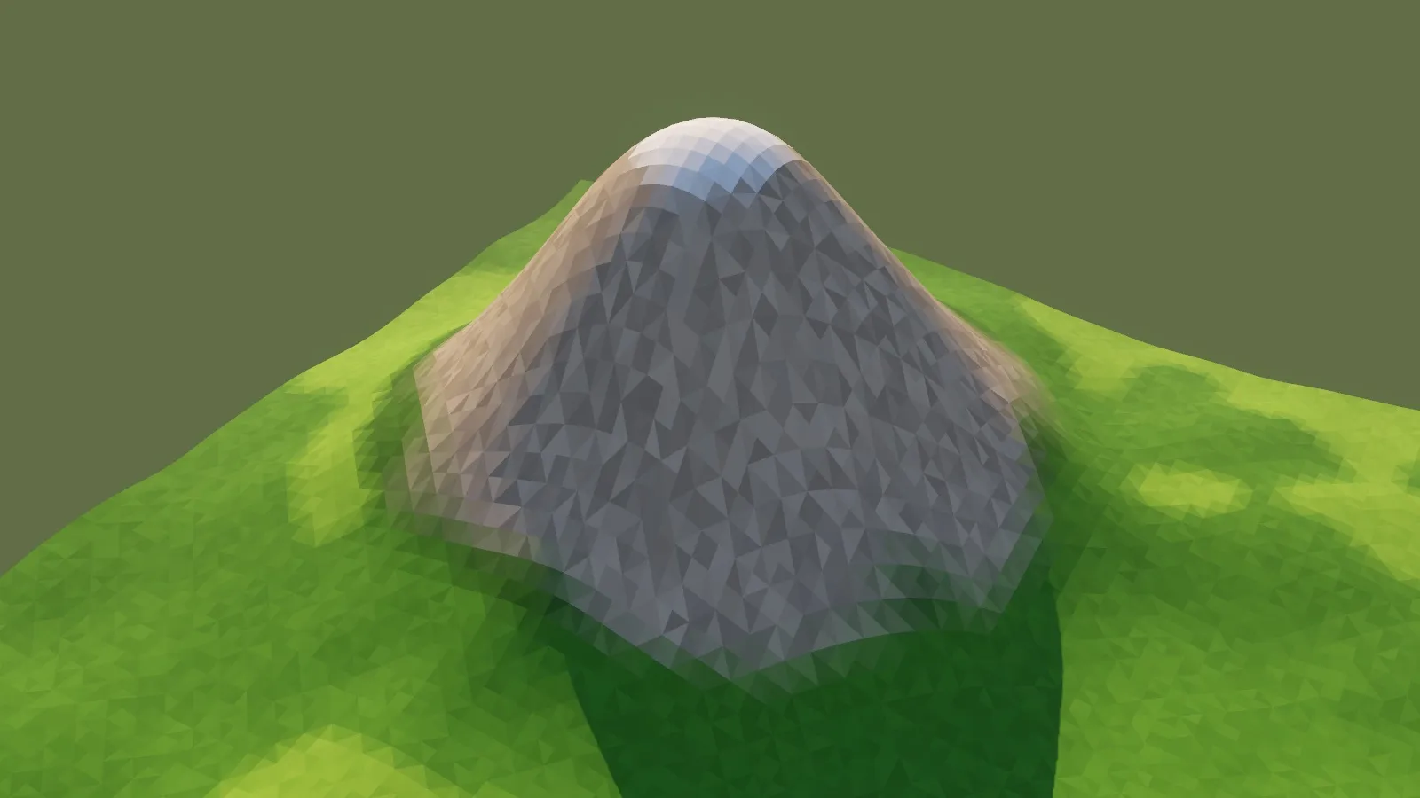A test hill: a grey rocky peak rising from faceted green grass