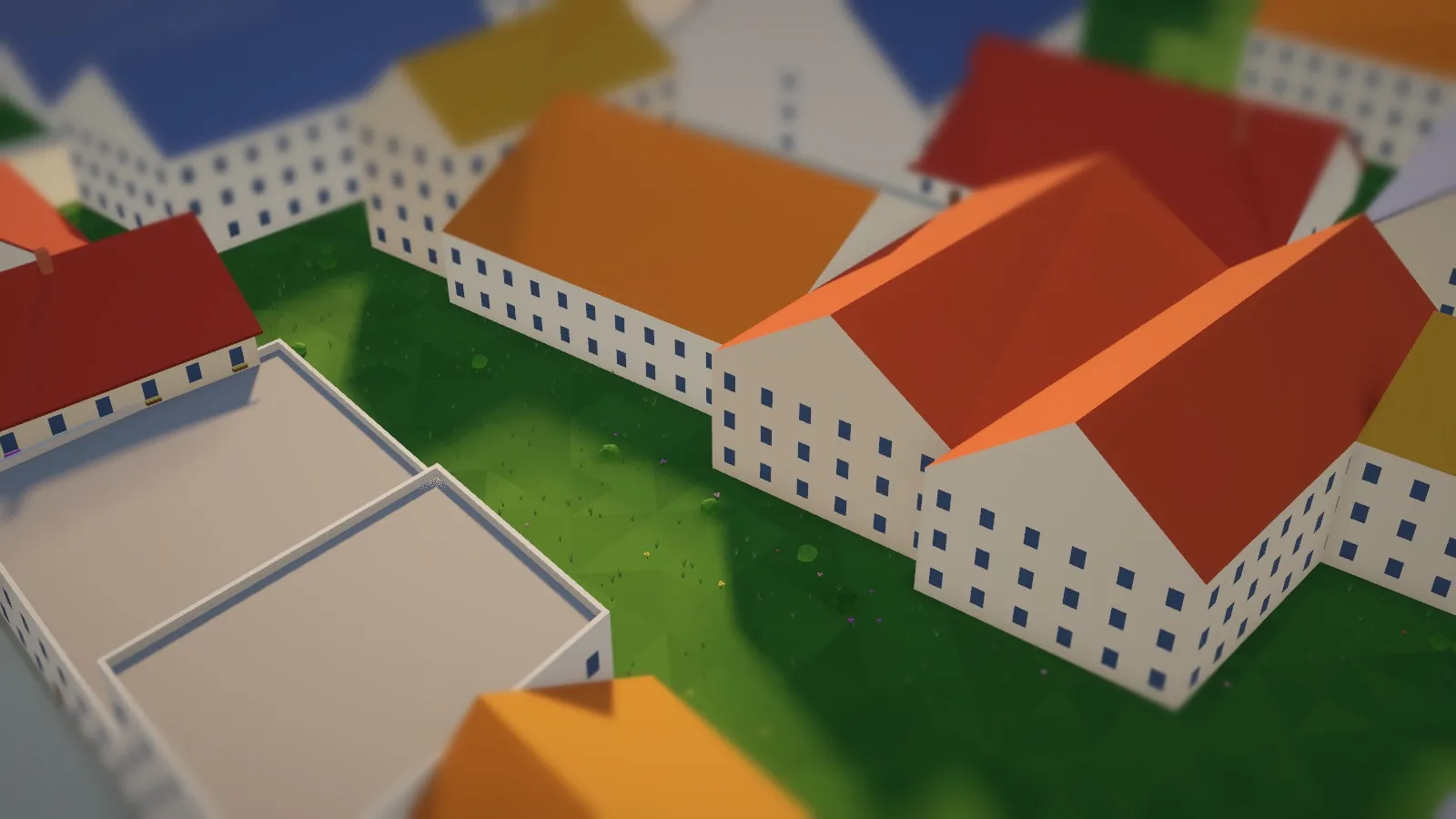 Close-up of houses with pitched roofs, rows of windows and a lawn between them